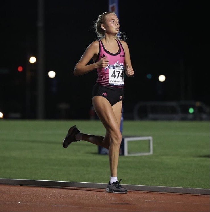 Danish student-athlete running on the outdoor track